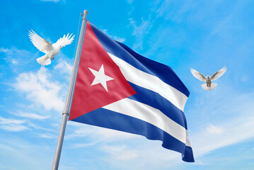 Waving flag of Cuba in beautiful sky and flying pigeons. Cuba flag for independence day. The symbol of the state on wavy fabric.