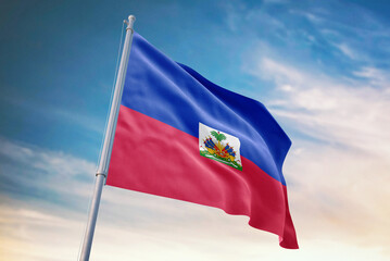 Waving flag of Haiti in blue sky. Haiti flag for independence day. The symbol of the state on wavy fabric.