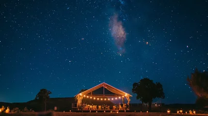 Poster Dramatic shots of the stage under a starry night sky for an outdoor wedding. © Naila