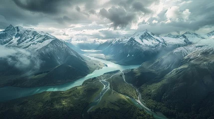 Fotobehang A birds eye view shows a mountain range with a river meandering through the peaks and valleys. © pham