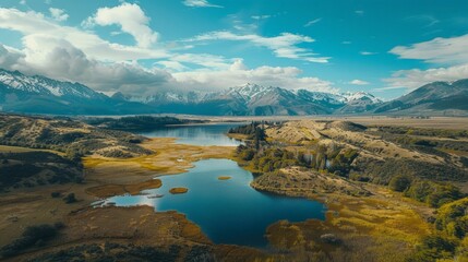 Fototapeta premium A birds eye view of a vast lake nestled among towering mountains in a scenic landscape.