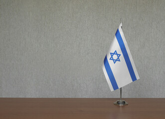 Israel table flag on gray blurred background