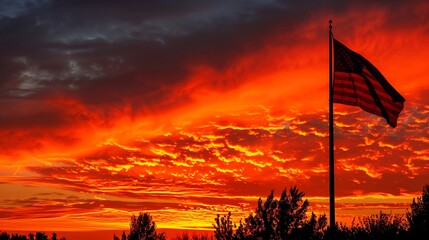 American flag flying high against a fiery sunset