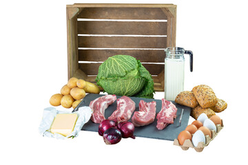 Transparent background. Food Vegetables, potatoes, meat, bread, eggs and milk isolated in front of a wooden fruit crate.