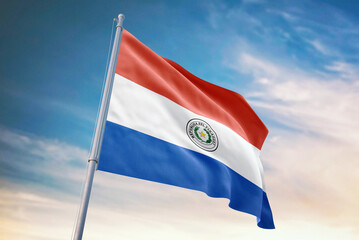 Waving flag of Paraguay in blue sky. Paraguay flag for independence day. The symbol of the state on wavy fabric.