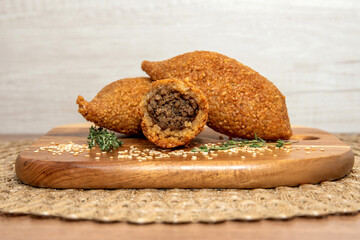 Kibbe traditional Arabic food, known in Brazil as Quibe. Kibbe is a fried food stuffed with minced...
