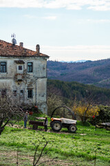 Rural scenery of istrian Croatia with an old tractor and a stone house surrounded by mountains