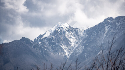 Fototapeta na wymiar Snowy mountain in winter on a cloudy day
