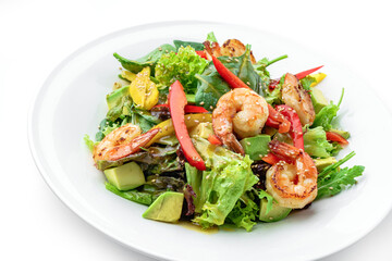 Healthy fresh salad with shrimp or prawns, avocado, lettuce, spinach, sesame, bell pepper and sauce in plate isolated on white background. Healthy food, top view
