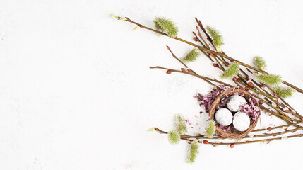 Nest with small eggs, willow branch, easter holiday greeting card, spring season
