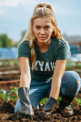 Woman wearing a green t-shirt and denim jeans, embodying the casual yet active nature of gardening. Her hands in gloves, are delving into the rich, brown soil.