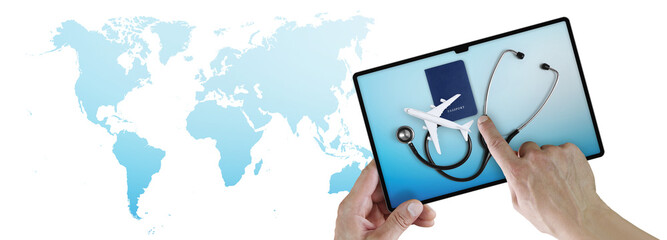 Top view of Hands pointing a digital tablet device with passport, airplane and stethoscope on the screen, Concept of medical insurance travel or health and safety, isolated on world map background