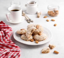 Almond cookies, served with coffee on plate on light table, Paste di Mandorle