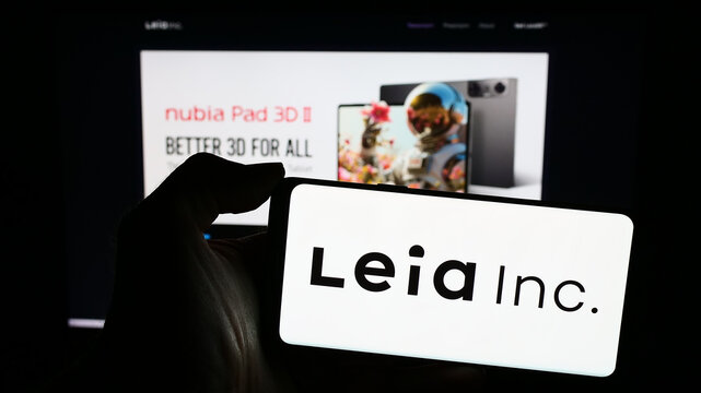 Stuttgart, Germany - 03-12-2024: Person holding smartphone with logo of US 3D display company Leia Inc. in front of website. Focus on phone display.