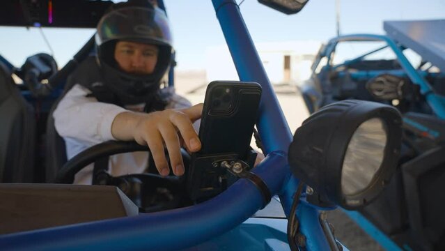 Offroad car UTV and driver using phone