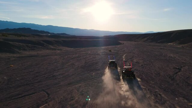 Side By Side UTVs Racing through the Desert Canyon