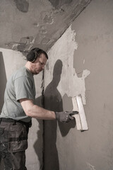 Worker Plastering Wall: Expert Renovation in Progress Inside Living Space