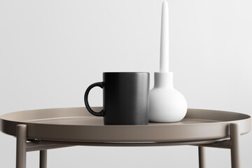 Black mug mockup with a candle on the beige table.