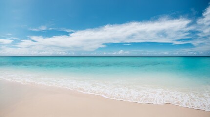 Fototapeta na wymiar Deep blue sea embraces a sandy shore beneath a calm sky filled with clouds 