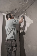 Artisan Skill: Precise Wall Smoothing by Worker Using Spatula in Interior Room.