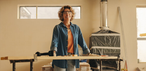 Smiling woman renovating kitchen with diy home improvement project