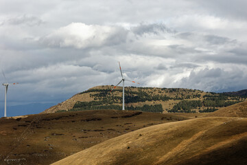 Wind farm or wind park at sunset located in the mountains of Italy Europe to realize clean energy. It’s sustainable, renewable energy for enviromental. Iconic location for landscape photographers blog