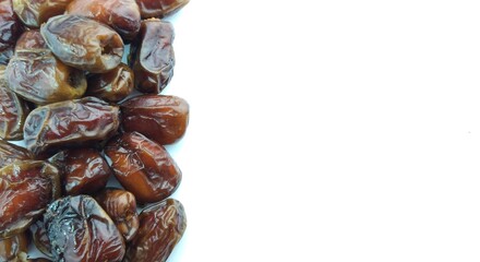 Dates fruit isolated on white background. Close up. Selective focus.