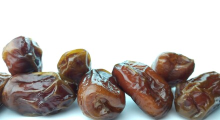 Dates fruit isolated on white background. Close up. Selective focus.