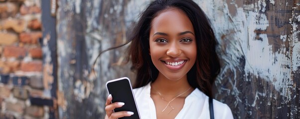 Smiling female entrepreneur holding smart phone and felt tip pen - obrazy, fototapety, plakaty
