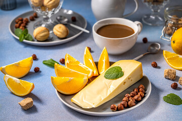 Coffee with milk, cheese and citrus fruits
