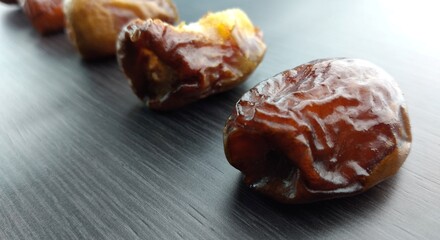Dried dates on a black background, close-up, selective focus