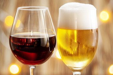 A glass of red wine and a glass of beer are shown next to each other