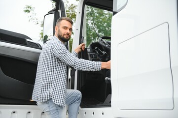 Truck driver climbing into cab of semi-truck