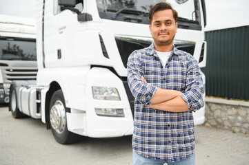 Portrait of confident indian truck driver on parking. Copy space