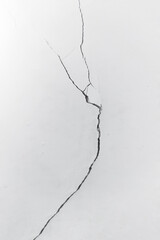 Cracked concrete wall. Crack on white wall close-up. The concept of brokenness, broken life, broken family. A symbol of mental health problems