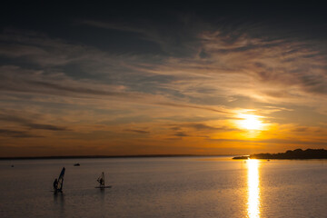 Windsurfing on the lake at sunset - 761791929