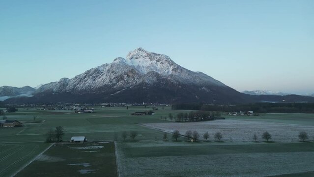 Scenic drone footage of the snowcapped Untersberg Mountain in Salzburg, Austria. Shot via drone in 4k at both sunrise and sunset. Along with the small town at the bottom of the mountain.