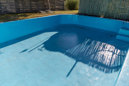Portion of a fibreglass lined empty resort swimming pool. Concept for fixing cracks in old pools with a fibreglass lining.  