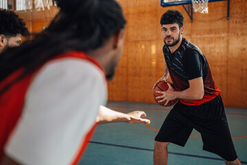 Picture of stealing a basketball on training. Interracial team on training.