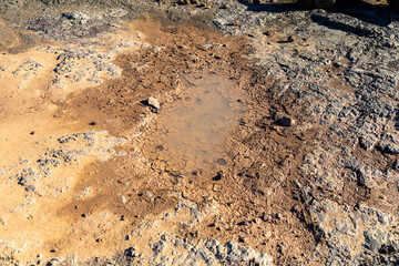 Almost dried up riverbed and rocks with a small patch of water remaining in the middle.  Concept for drought in arid regions. 