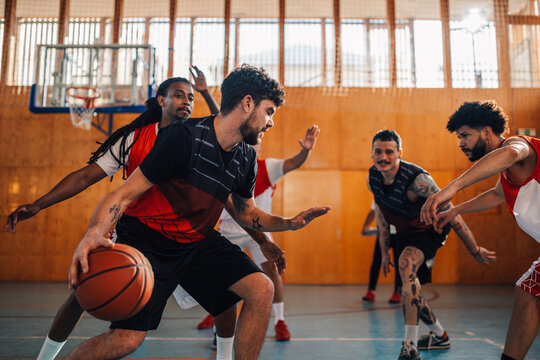 Interracial basketball team is practicing basketball on training. - Powered by Adobe