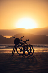 Fototapeta premium bike on the beach at sunset in Santos, brasil
