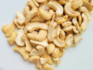 Portion of cashew nuts on a bright background.