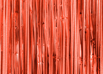 Red orange foil strip background. Curtain hanging on wall. Festive, Christmas, New Year or...