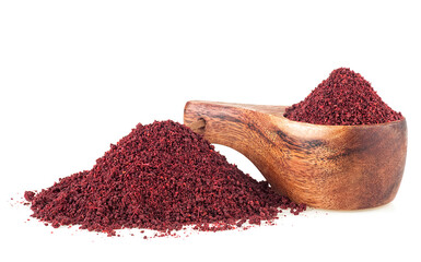 Dried ground red sumac powder spices in wooden spoon isolated on a white background. Healthy food concept. - 761805304