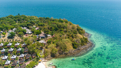 Beach villas overlooking blue lagoon of Andaman sea at Koh Phi Phi island, Krabi, Thailand.  Aerial view. 
