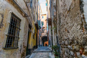 A residential area of narrow alleys, tunnels and stairs in the hillside district La Pigna di Sanremo, the medieval old town of the coastal city of Sanremo, Italy in the Liguria Imperia region.