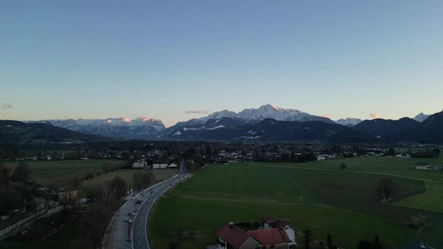 Scenic drone footage of the snowcapped Untersberg Mountain in Salzburg, Austria. Shot via drone in 4k at both sunrise and sunset. Along with the small town at the bottom of the mountain.