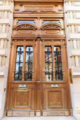Old ornate door in Paris - typical old apartment buildiing. - 761817771