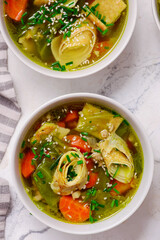 Cabbage soup with eggs roll in a ceramic bowl on a table.  .style hugge